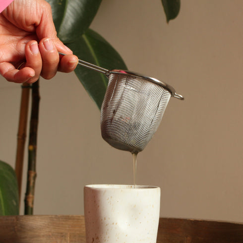 Colador de té de acero inoxidable con mango.